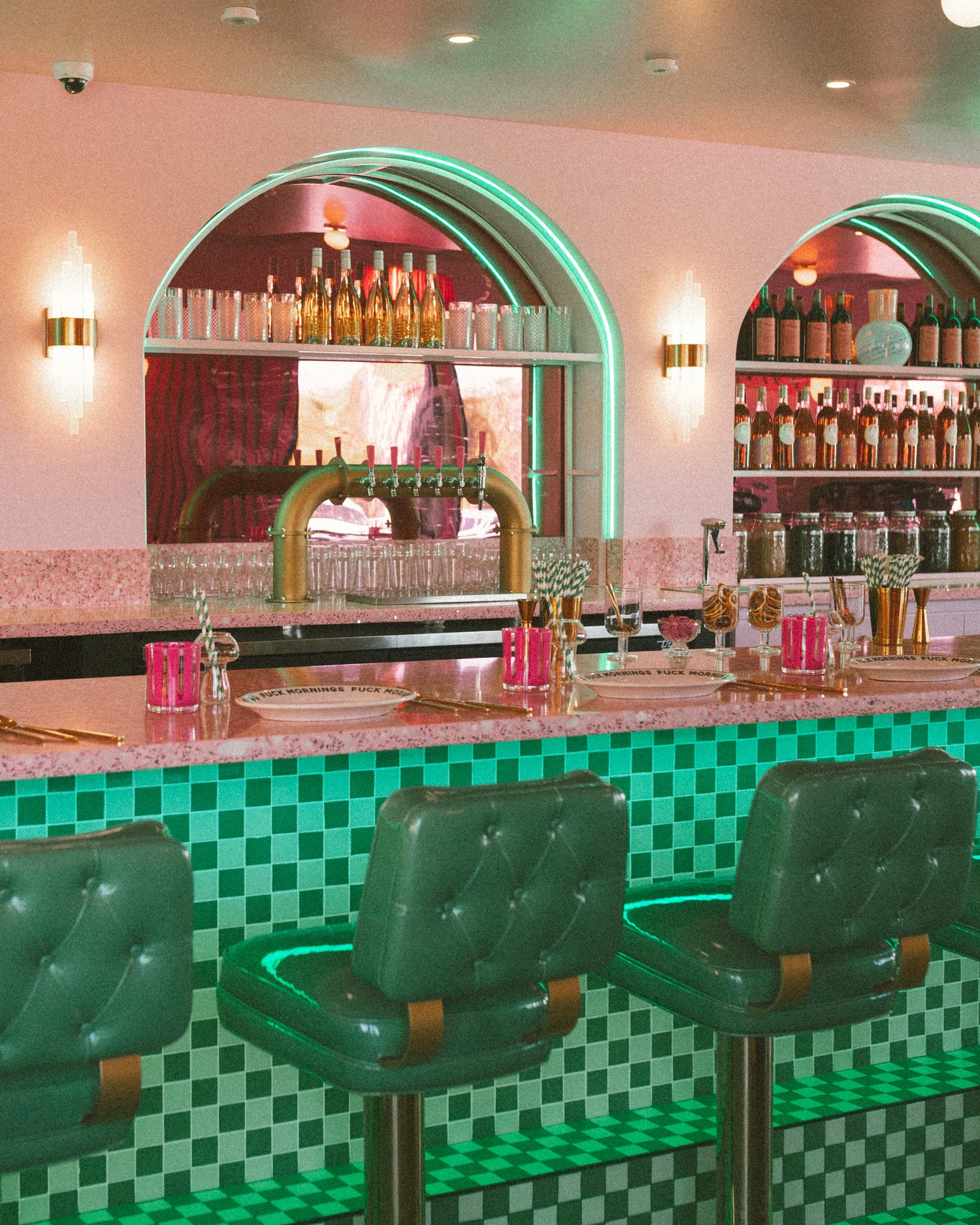 place settings at the bar, drinks behind the bar on shelves in perfect rows