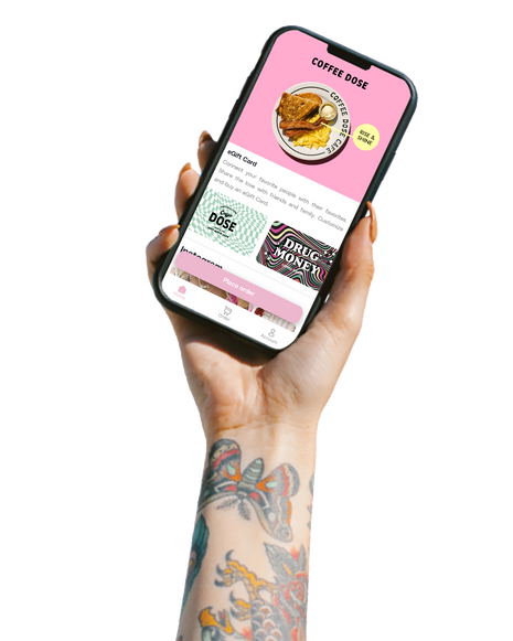 hand holding up smart phone with coffee dose ordering app on screen