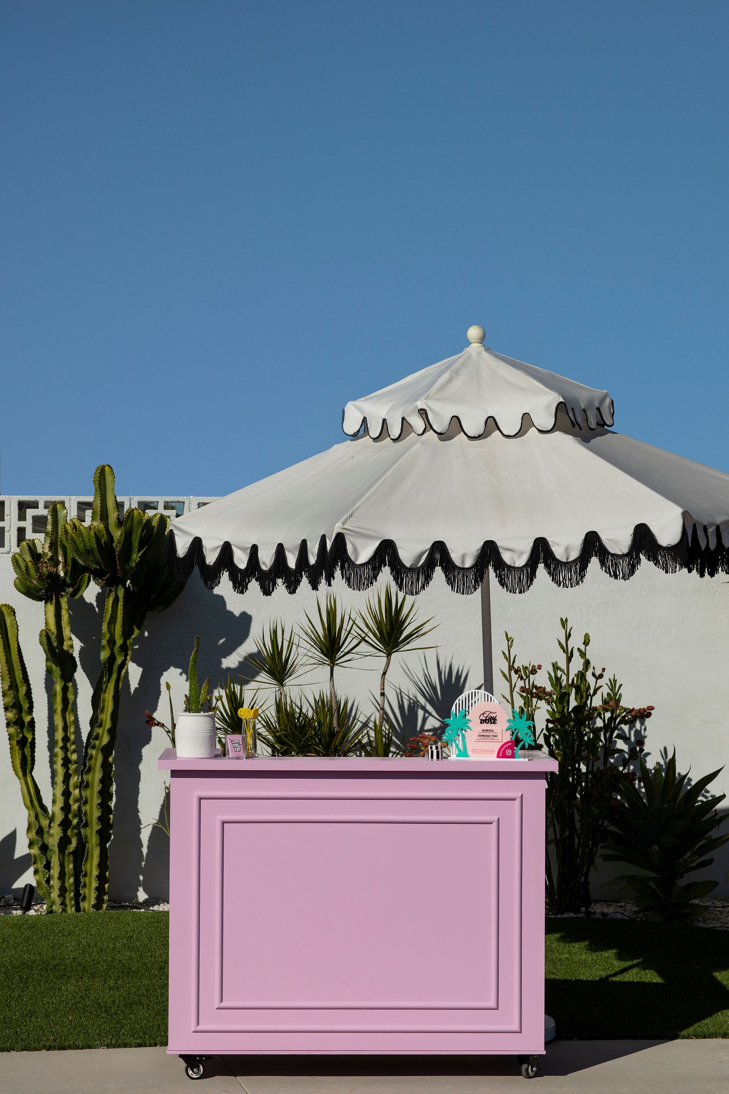 cute pink bar with large white umbrella