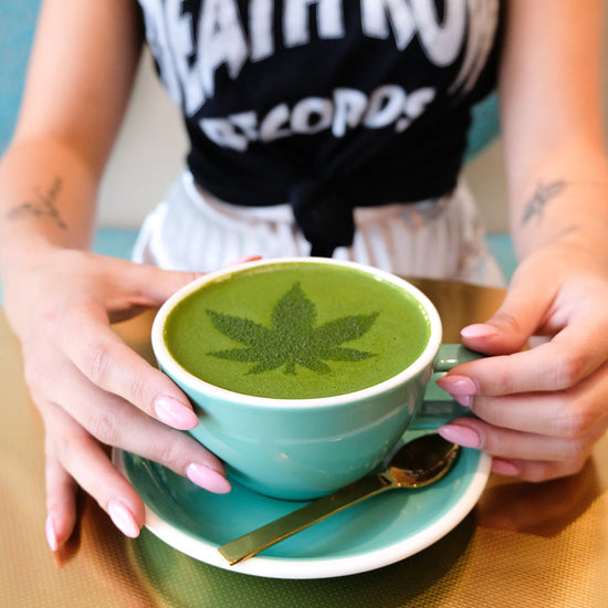 tea drink with green leaf design in foam